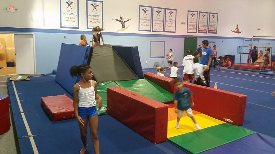 Kids running an obstacle course during a camp at El Paso Gymnastics