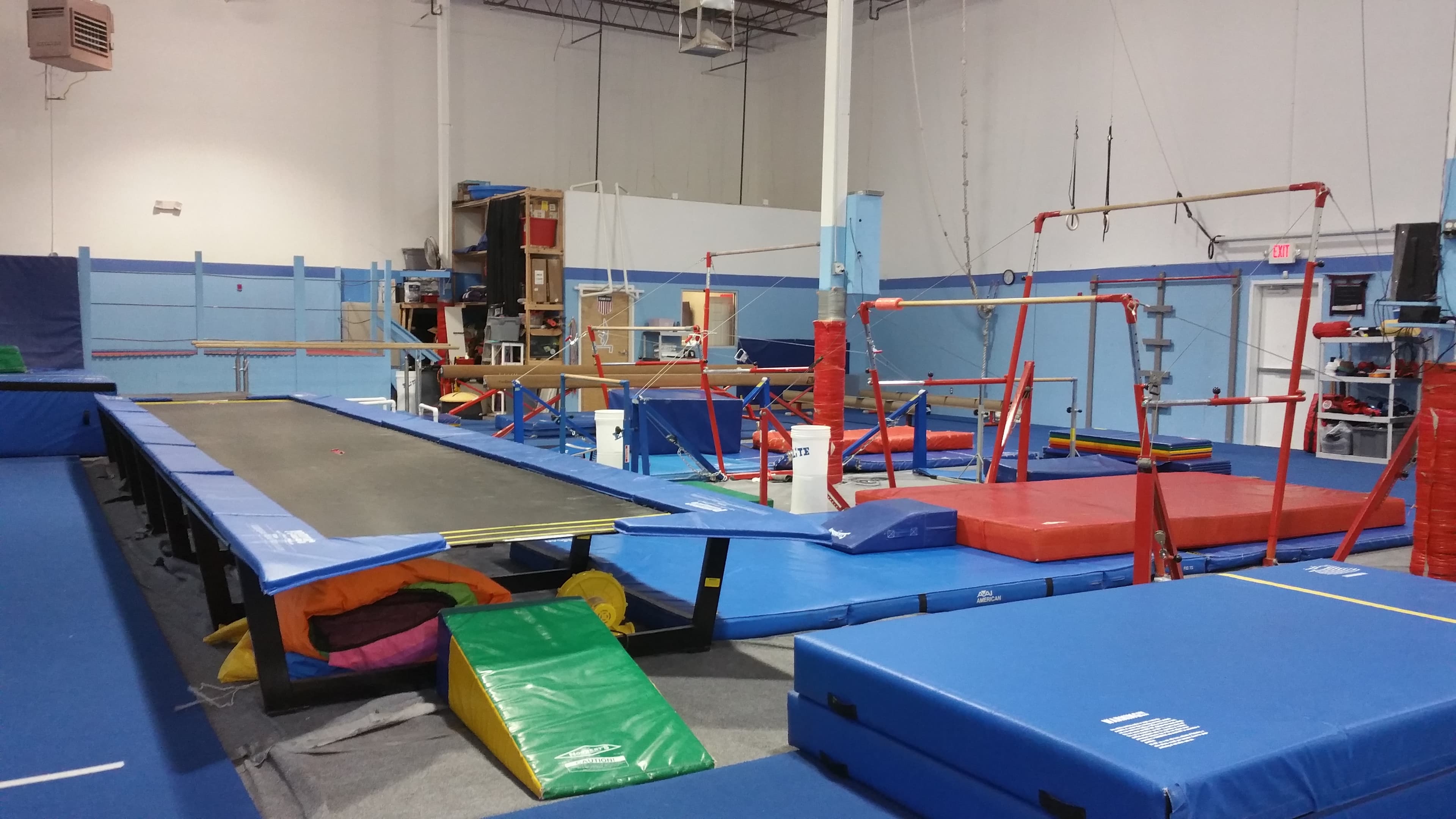 El Paso Gymnastics training floor with trampoline pit and bars