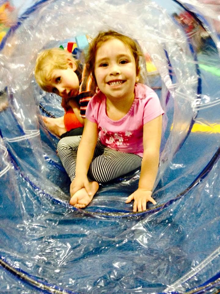 Toddlers playing in a tunnel at El Paso Gymnastics