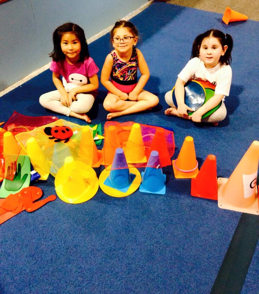 Campers sitting with camp gear at El Paso Gymnastics