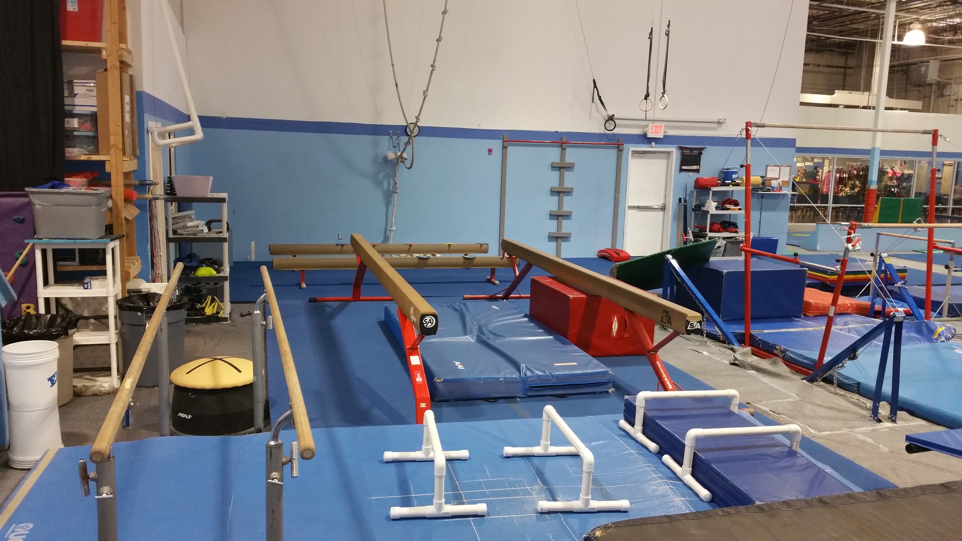 El Paso Gymnastics training floor with beam, bars, and rings